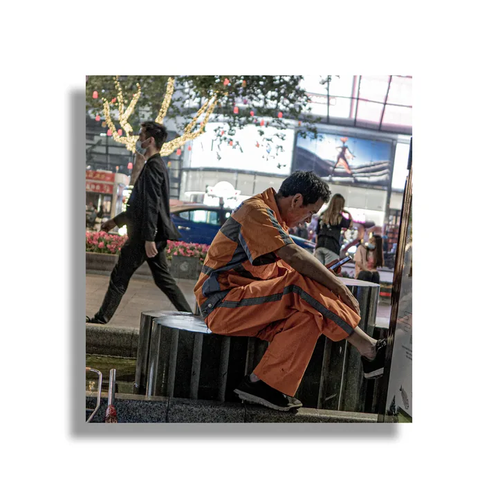 Person seated beside a street stall