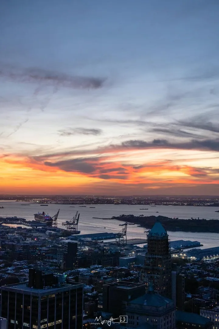Sunset clouds above a waterfront city