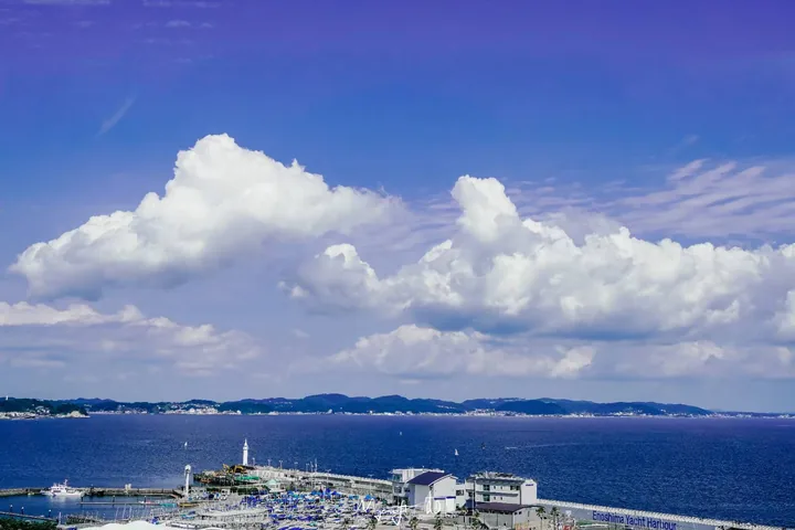 White clouds over a blue bay and harbor